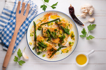 Grilled swordfish with green asparagus. Top view table with  decorations.