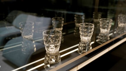 Empty crystal glasses shining on a shelf in a contemporary design furniture store.