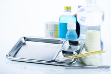 Medical equipment for treating infections. Wound care dressing set. Medical supplies for nurses. Conform bandage, forceps, cotton stick, alcohol. Sterile dressing materials. Healthcare equipment.