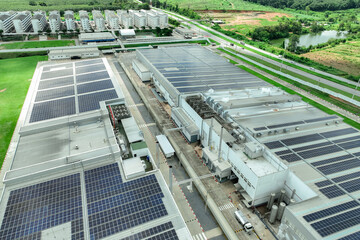 Solar energy for factory and warehouse building. Solar panels on roof of industrial plant. Commercial solar power. Rooftop solar power. Rooftop renewable energy system. Sustainable green energy.