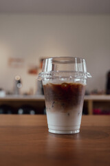 Iced coffee latte with two layer on wood table