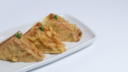 Roti Goreng is common fritter snack in Indonesia which made of white bread filled with creamy chicken and vegetable.