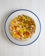 Healthy white cabbage, corn and turkey salad. Top view table with decorations.