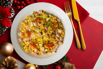 Healthy white cabbage, corn and turkey salad. Top view table with Christmas decorations.
