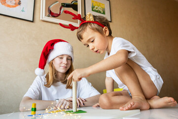 Children at home on New Year's Eve chatting with each other at table. Merry Christmas Happy New Year