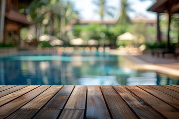 Blurred view of a swimming pool with wooden deck in front.