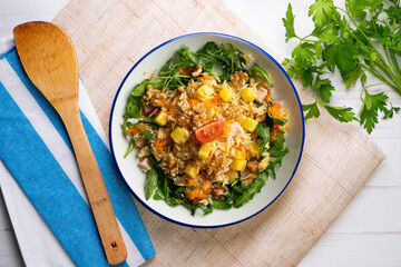 Healthy rice, pineapple and turkey salad. Top view table with  decorations.