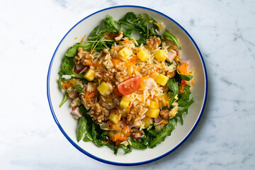 Healthy rice, pineapple and turkey salad. Top view table with  decorations.