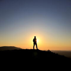 Person Silhouette with Sun Setting Behind