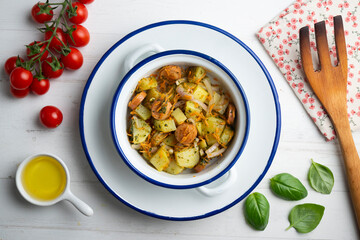 Healthy potato, onion and sausage salad. Top view table with decorations.