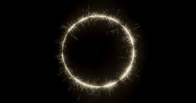 A sparkling firework sparkler forming a circle shape on a dark black background with alpha