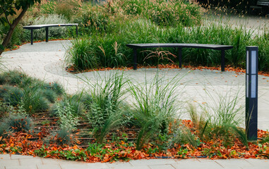 green city square street tile flower bed with irrigation system and empty bench landscaped design...
