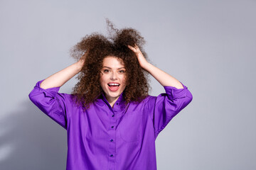 Photo of nice young woman touch hair empty space wear purple shirt isolated on grey color background