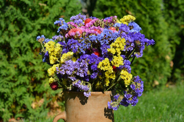 Ceramic vase with dried flowers. 
beautiful natural background