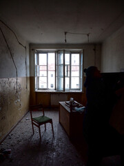 Interior of an Abandoned Mental Hospital: Broken Furniture and Empty Room. Urban Decay and Haunting Atmosphere