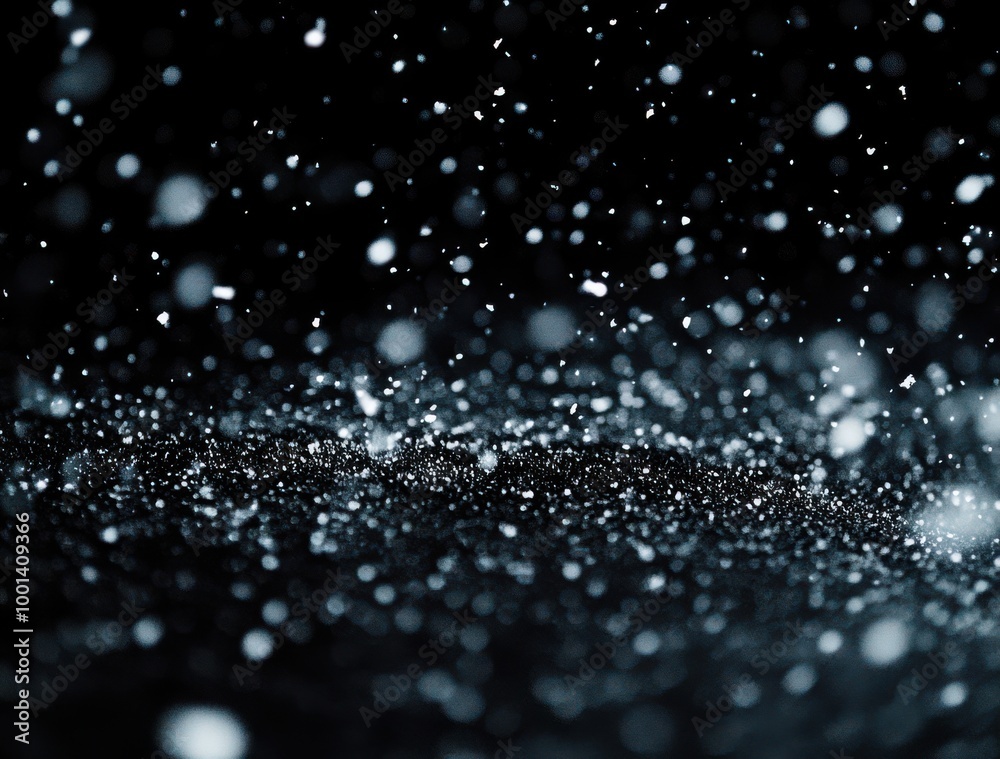 Wall mural snow falling on a black background, with snowflakes and particles in a depth of field
