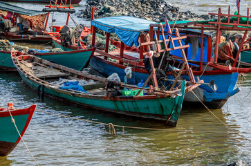 Fishing boats and crab fishing traps moored on the coast of Kep in Cambodia