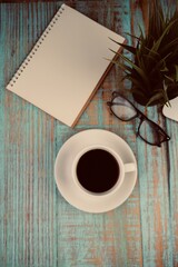 education and back to school concept. alarm clock, scissors, colorful pens, and paper clips over yellow background. top view, flat lay. blank white paper for text space. 