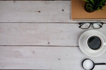 education and back to school concept. alarm clock, scissors, colorful pens, and paper clips over yellow background. top view, flat lay. blank white paper for text space. 
