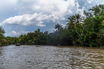 Small paddle boats and sampans in the narrow water canals in Ben Tre in Vietnam