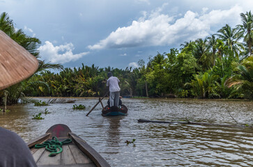 Small paddle boats and sampans in the narrow water canals in Ben Tre in Vietnam