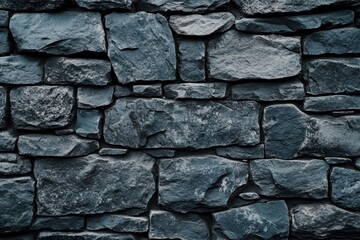 Obraz premium stone wall background is made of rough rocks, with a clear texture and a gray color tone