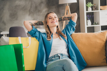 Photo of blonde hair shopaholic woman lying comfortable couch take nap relaxed and satisfied dreaming apartment indoors indoors