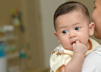 cute cheerful baby in mother hand. emotion infant