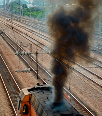 A railway diesel locomotive emitting thick smoke
