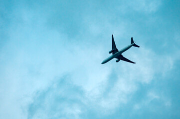 An airplane flying in a cloudy sky