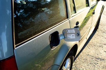 concept of rising fuel prices. Empty car tank. Car with open gas filler flap