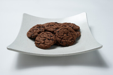 Chocolate chip cookies are sitting on a plate
