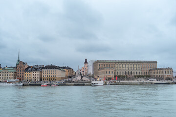 Fototapeta premium A picturesque panoramic view of Stockholm, Sweden. The iconic Skeppsholmsbron bridge, with its golden crown, stands out against the city skyline.