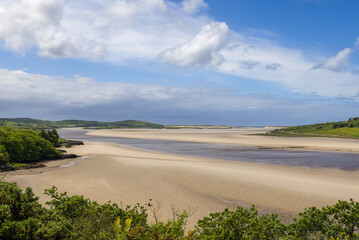 Gweebarra Bay tidal shores in Ireland reveal extensive sandy expanses and meandering streams, showcasing the beauty of the Atlantic coastline