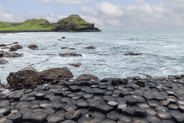 Basalt hexagonal columns of Giant's Causeway meet the Atlantic Ocean in Northern Ireland, with...