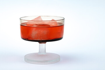 Red liquor glass on white background.