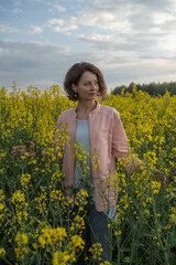 Fototapeta premium Portrait of a young beautiful fair-haired girl in nature.