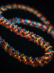 A glowing helix of beads, reminiscent of DNA, lights up the dark.