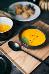 Pumpkin soup with cheese and ham pies in puff pastry