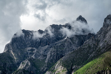 Mountain peaks surrounded by mist in high-altitude areas