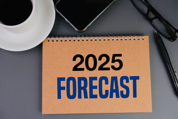 word of 2025 forecast on brown notebook as a market predictions notes background. Expectations...
