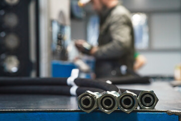 Worker assembles high pressure hose. High pressure hose production.
