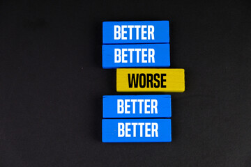 two opposite colors with words BETTER or WORSE on the wooden block as different concept