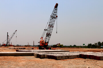 Fototapeta premium Concrete pile construction of new building at construction site. Square pile foundation for soil