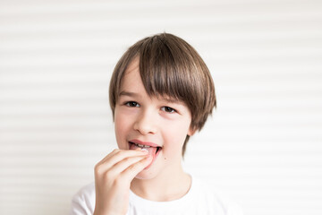 Happy boy puts the pill into his mouth. Close up portrait of child with pill on hes tongue at home ,taking medicine, taking vitamins,medical, nutrition, healthcare concept