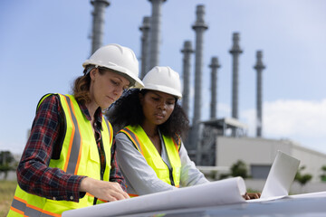 Right data drives your business to accomplish your goals. Super Power Girl collaboration at a thermal power plant work with a blueprint to follow up on building project 