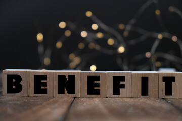 text of BENEFITS on wooden blocks scattered on the wooden table as a financial and management concept. return on investment. investment concept