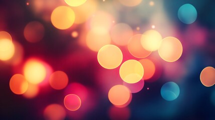 Abstract blurred background with colorful bokeh lights in red, yellow, and blue on a dark background.