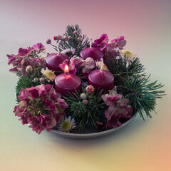 advent wreath with four red candles, 1 candle burning, purple tone
