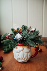 Winter Christmas bouquet in funny bowl on the table by the window. 
